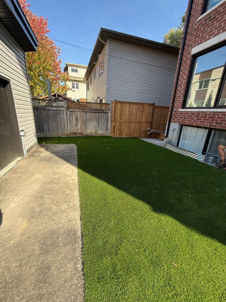 Completed artificial turf lawn with concrete borders