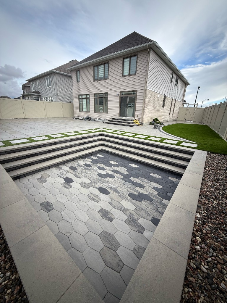 Multi-level turf and interlock patio